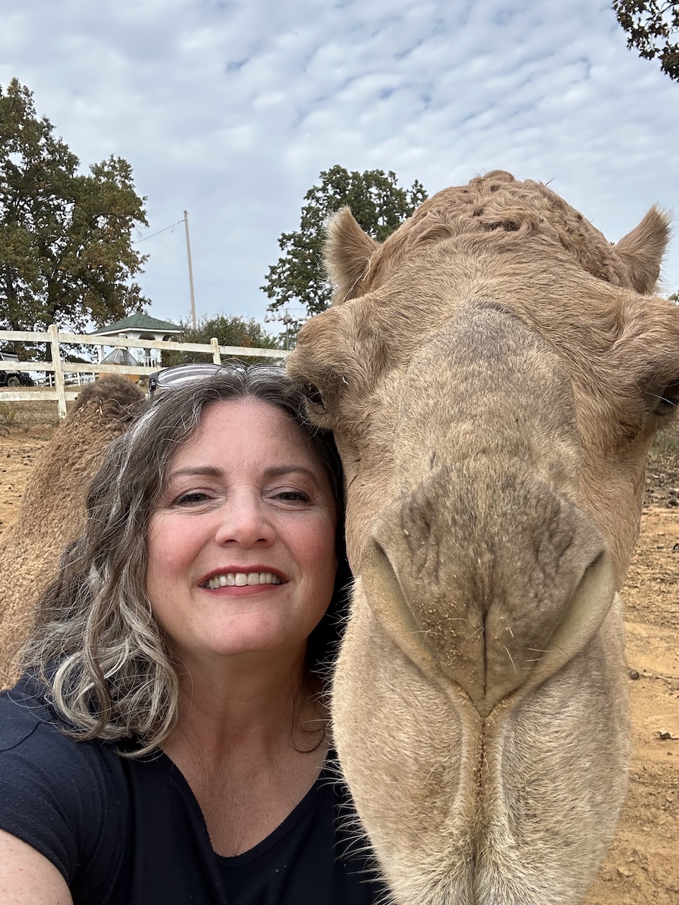 Tutor Amanda McGee posing with a camel