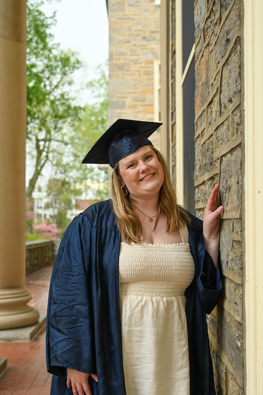 Tutor Liz Kittle, posing in her graduation cap and gown