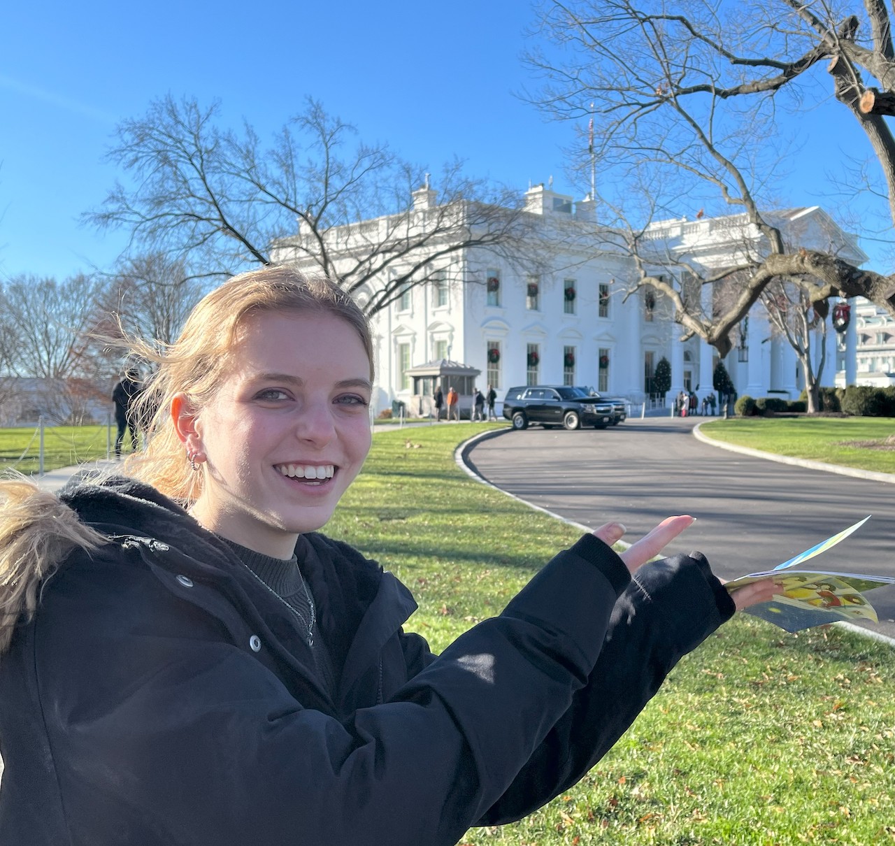 Tutor Grace Anne Hodgson posing in front of the White House